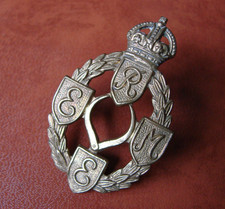 WW2 REME Royal Electrical Mechanical Engineers brass cap badge with two lugs.