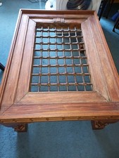 A wrought-iron medieval metal window grille is built into a unique teak and oak 
