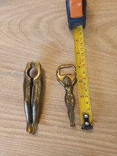 Brass novelty nut crackers and nude lady bottle opener