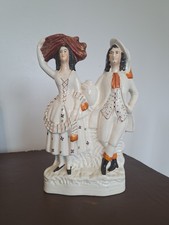 VICTORIAN STAFFORDSHIRE POTTERY FIGURE OF A SCOTTISH COUPLE AT HARVEST TIME. 