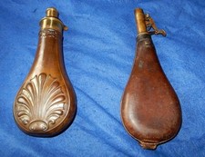 An original shell powder flask by G & J W Hawksley of Sheffield with shot flask.