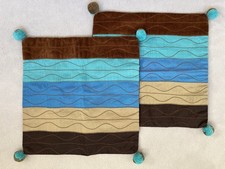 2 x CUSHION COVERS WITH POM POMS. BROWN/ BLUE. 12” x 12”.30 x 30cm