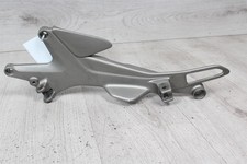 Footrest retaining plate