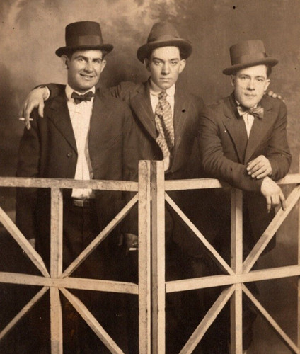 Rppc three men stand behind - three,