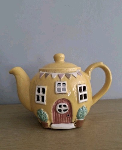 Yellow tea pot house - tea,