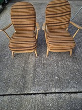 A Pair Of Mid Century Blonde Ercol 203 Armchairs 