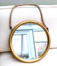 A Round Wall Mirror With A