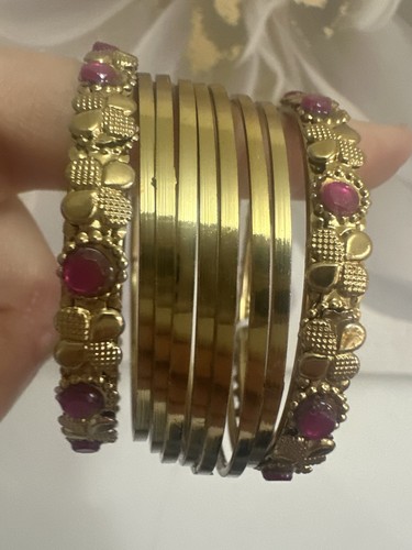 Gold bangles with pink jewels - with,