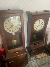 Pair of Gledhill-Brook Time Recorders Ltd - oak cased clocking-in clocks. 