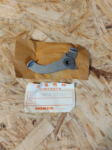 Distribution tensioner arm