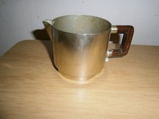Vintage small silver tone metal milk jug. Wooden handle. 7cm.DAMAGE.(E14)