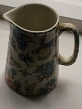 Heron Cross Pottery milk jug with butterfly and floral print