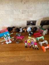 Toy horses, riders, jumps and saddles