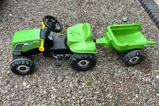 Green, pedal, sit on tractor and trailer made by Rolly Toys