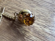 Vintage tie tack . Gold tone and amber/ yellow stone. Good condition 
