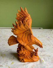 carved wood eagle with wild