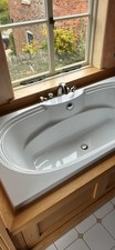 Large bath with taps and