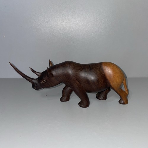 Hand carved wooden rhinoceros - hand,