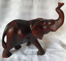 HAND CARVED WOODEN ELEPHANT WITH UPWARD POINTING TRUNK