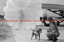 F002210 USAF airman adjusts the parachute harness of Trixies at Fort Benning Geo