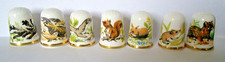 SEVEN CAVERSWALL CHINA THIMBLES OF WILD ANIMALS SIGNED C. NUNN 