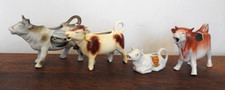 A collection of 4 Cow Creamers. Goebel and Grovenor Ware