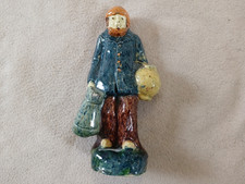 Majolica pottery figure of man carrying jugs