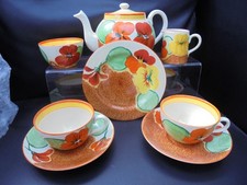 A Clarice Cliff Bon tea for two set in NASTURTIUM pattern.