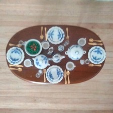 Dolls house dining table with dinner service all items can be moved.