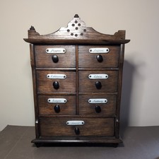 Antique Victorian wooden spice chest with original handles and porcelain labels.