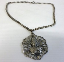 SILVER TONE METAL NECKLACE WITH LARGE PENDANT SHOWING A BUDDHA