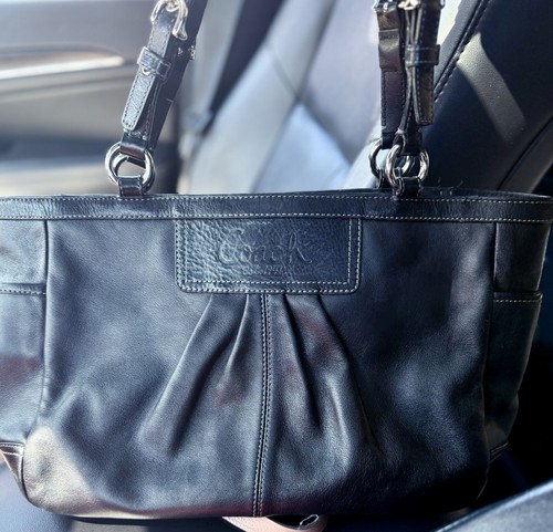 Coach black leather east - east, west