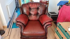A beautiful, comfortable antique armchair made of red leather, good condition 