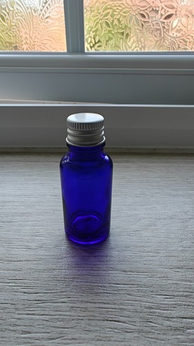 Small blue glass bottle with - small,