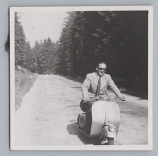Man on scooter Vespa 98