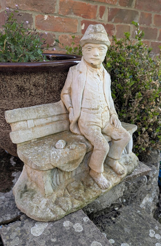 Stone seated man figure - figure, on