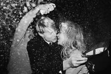 Police officer embraces a young woman, holding his custodian helmet - Old Photo