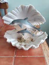 Dolphins in clamshell water
