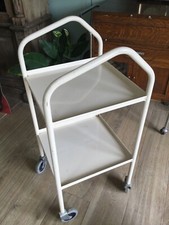 Cream, medical utility trolley on wheels. Drinks gin trolley.