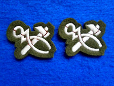 A PAIR OF NEW BRITISH ARMY ARMOURERS TRADE ARM BADGES