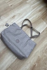 Kipling beige travel tote bag hardly used Metal Kipling monkey attached. 