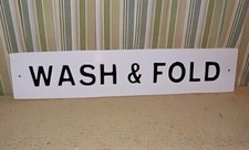 ENAMEL ON METAL SIGN ' WASH & FOLD ' 1/2 inch thick metal w/ raised text. 23 5/8