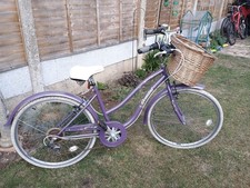 purple ladies bicycle with basket
