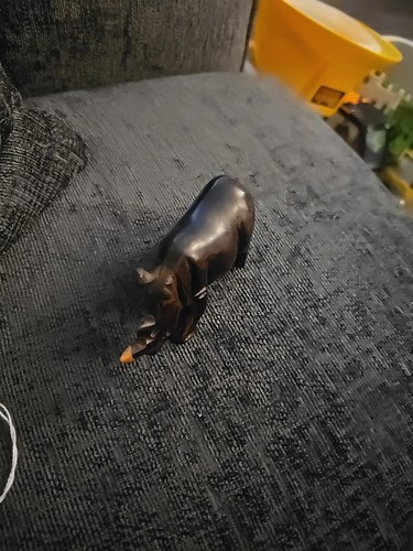 Wooden hand craved rhino - hand,
