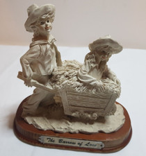 DECORATIVE ORNAMENT BOY and GIRL FIGURINE ON WOODEN BASE TITLED 'BARROW OF LOVE'