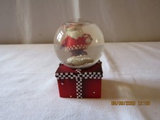SMALL SANTA  SITTING ON A