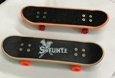 2 X Fingerboards Mini Skateboards With Artwork Under.  1- Stuntz, 1-unbranded.