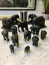Collection of 14 vintage ebony and ivory elephants. Including Ceylon bookends.