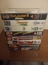 8 VHS tapes - Last Action Hero, Police Academy 6, Wrestlemania 6, Top Gun + more