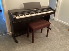 Roland RP102 piano and stool